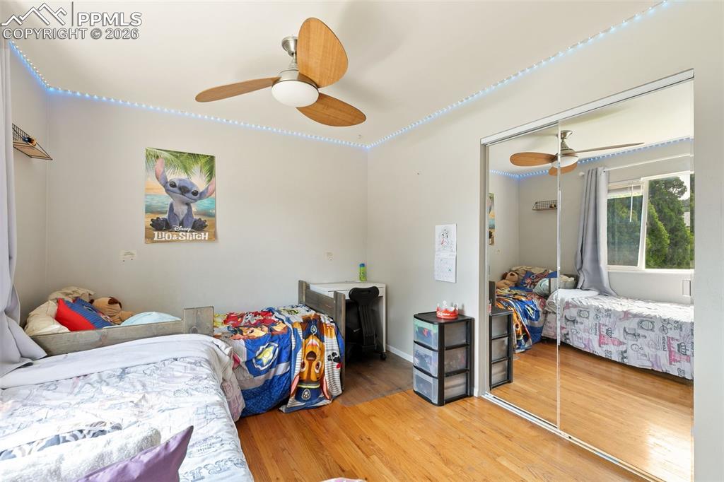 Image 21 of 38: Bedroom with wood finished floors, a closet, and ceiling fan