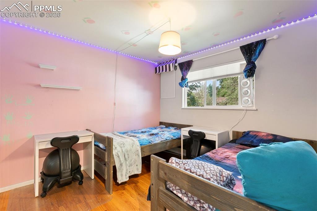 Image 22 of 38: Bedroom with wood finished floors and baseboards