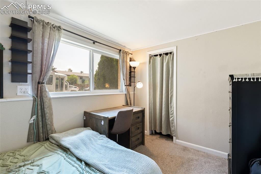 Image 28 of 38: Carpeted bedroom featuring baseboards and ornamental molding