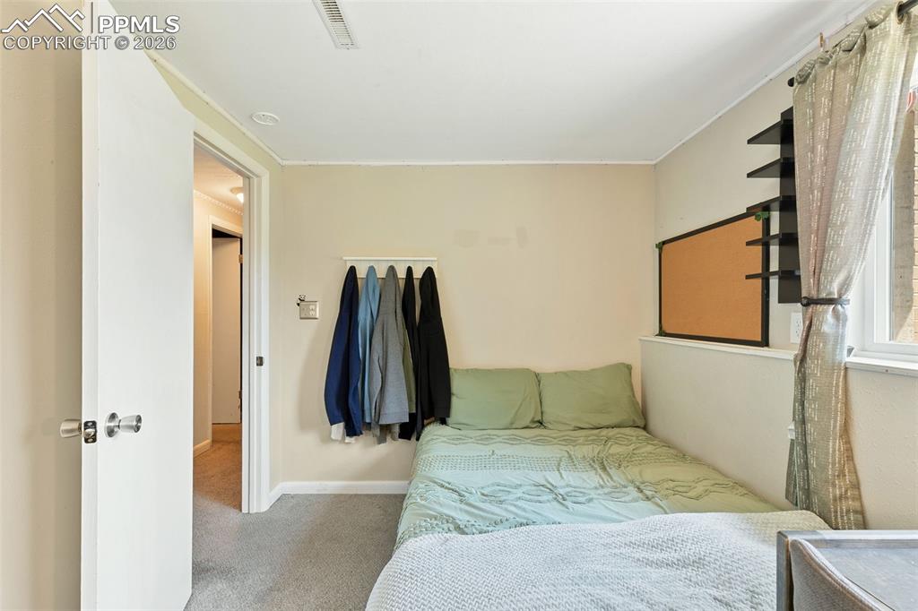Image 29 of 38: Carpeted bedroom featuring baseboards