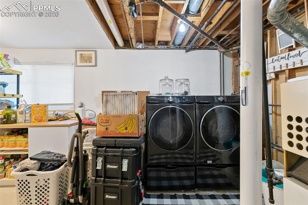 Image 34 of 38: Laundry area with washer and dryer