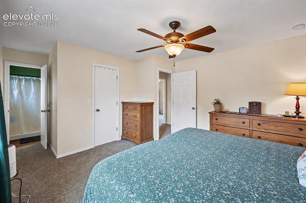 Image 23 of 44: Carpeted room featuring a ceiling fan with integrated lighting, neutral wal