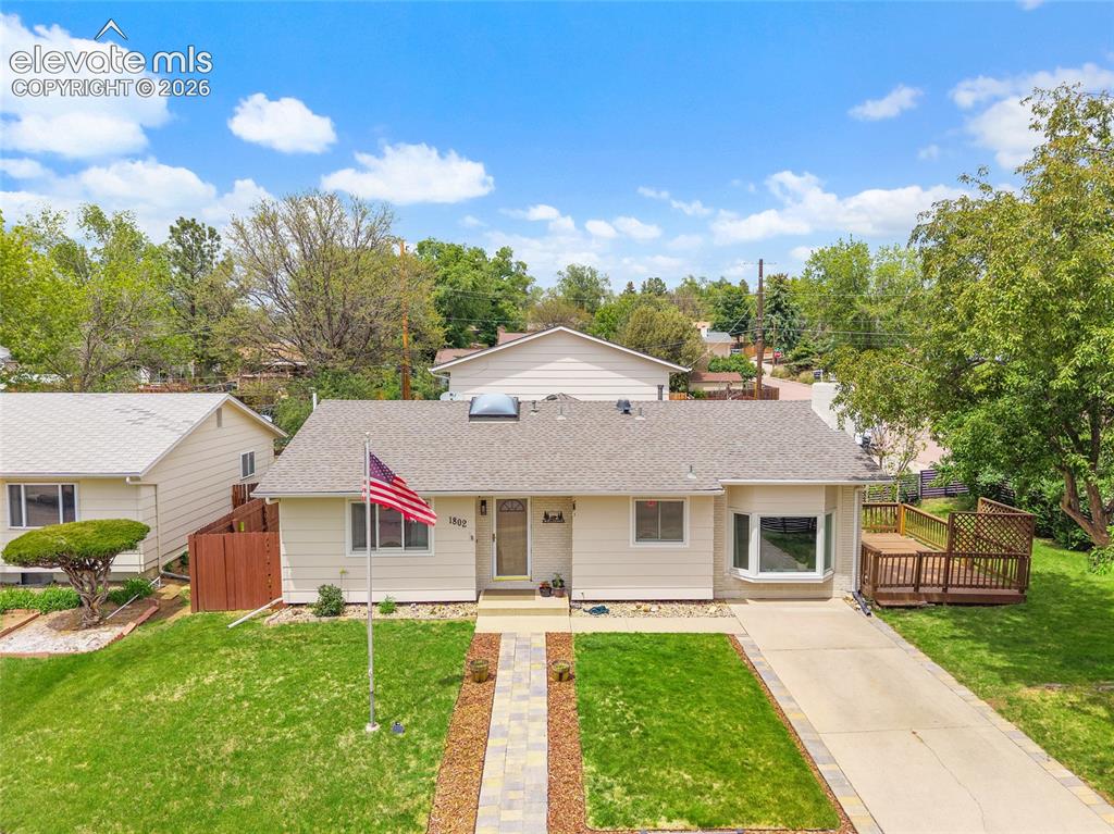 Image 3 of 44: Ranch-style exterior featuring a bay window, concrete driveway, front walkw