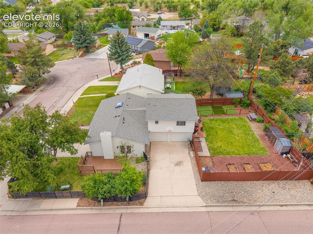 Image 38 of 44: Two-story residence featuring a two-car garage, a gray shingle roof, and a