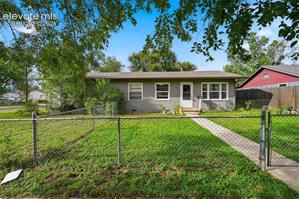 Caption: Single-story residence with a gray exterior, front entry door, and multiple windows