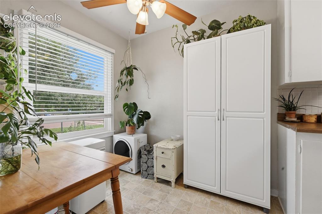 Image 26 of 32: Recessed lighting with a ceiling fan, white window blinds, white storage ca