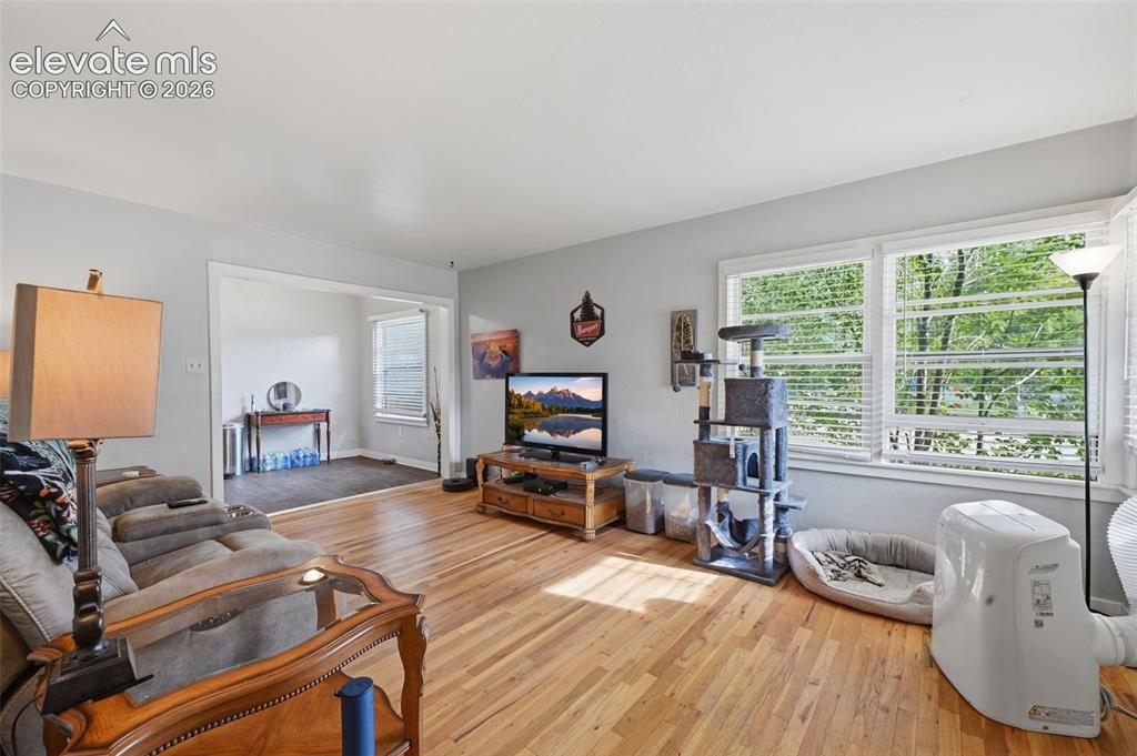 Image 8 of 32: Wood-finish flooring with light-toned wall paint and an open doorway to an 