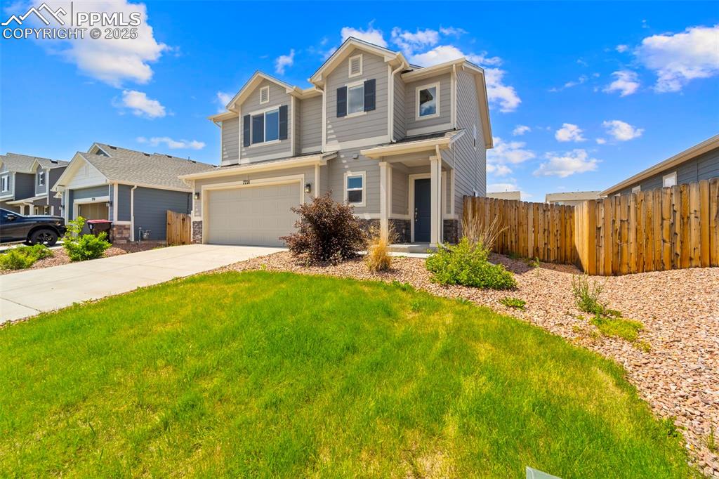 Image 12 of 35: View of front of house with a garage and concrete driveway