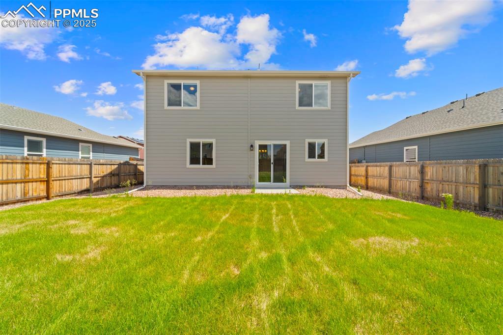 Image 24 of 35: Rear view of property featuring a fenced backyard
