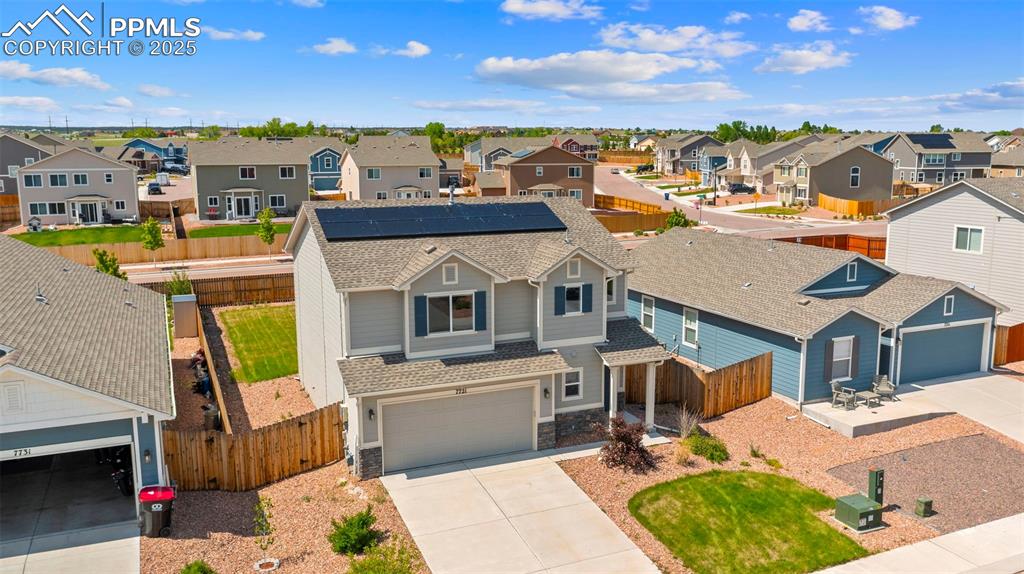 Image 3 of 35: View of front facade featuring a residential view, driveway, a shingled roo