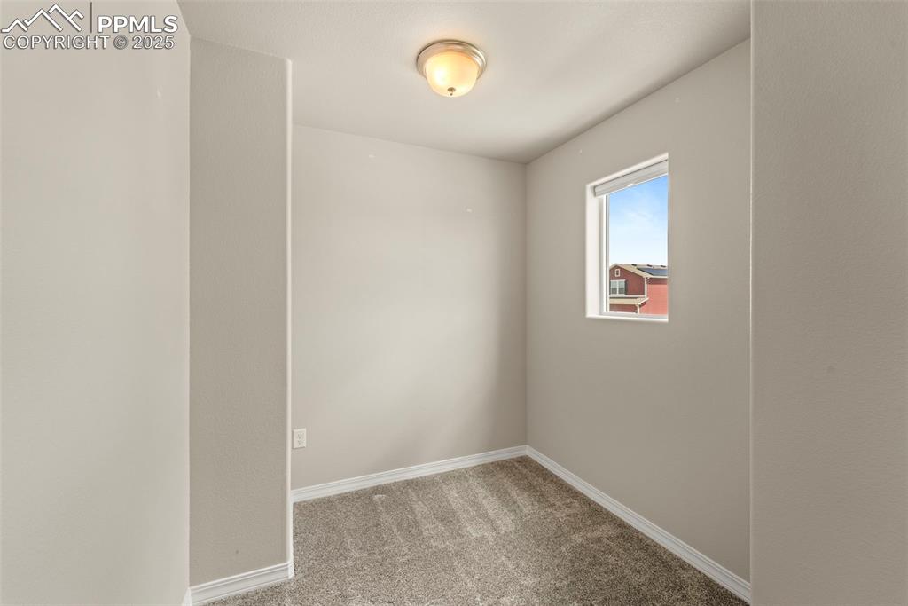 Image 31 of 35: Spare room with carpet and baseboards