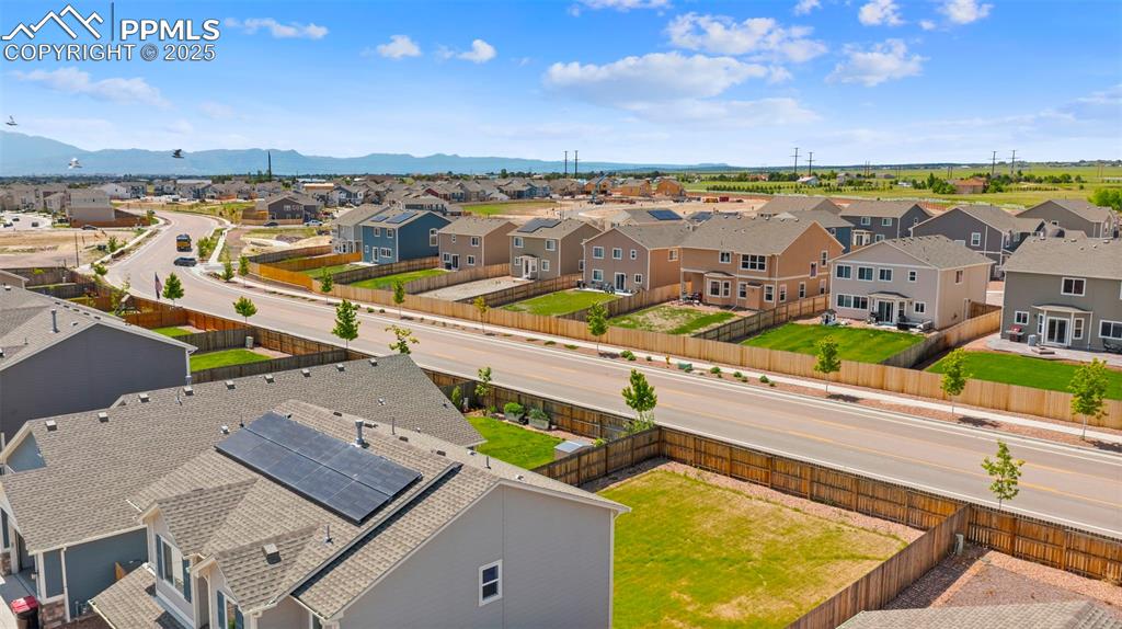Image 4 of 35: Aerial view of residential area with a mountainous background