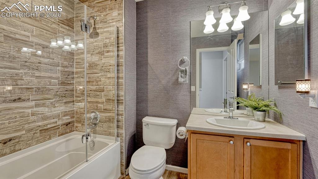 Image 18 of 24: Custom tile in secondary hall bath!