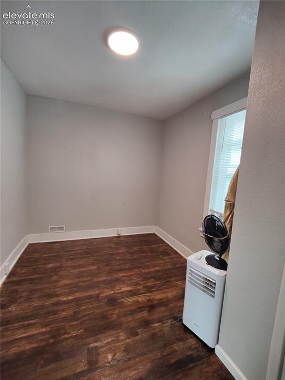 Image 11 of 13: Recessed ceiling lighting, wood-finish flooring, white trim, and window wit