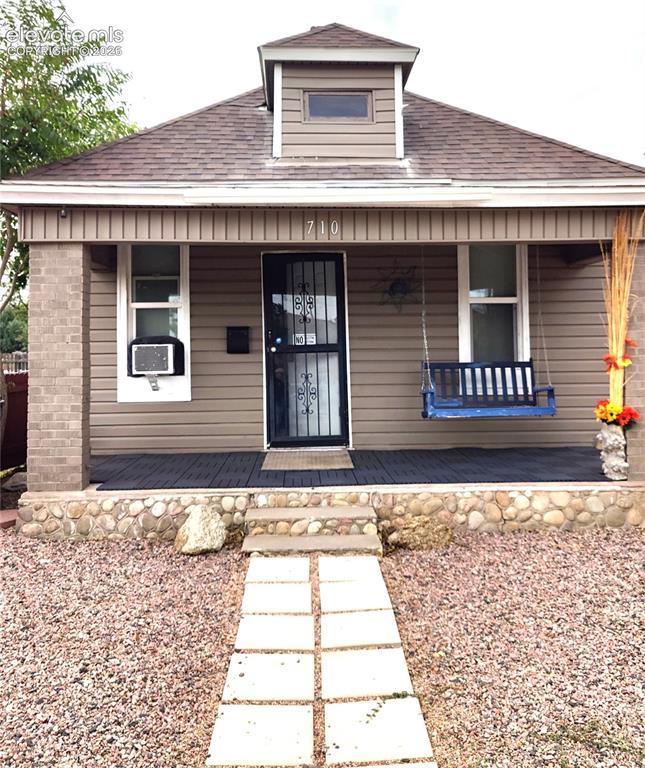 Image 2 of 13: Siding exterior with dormer window and covered porch