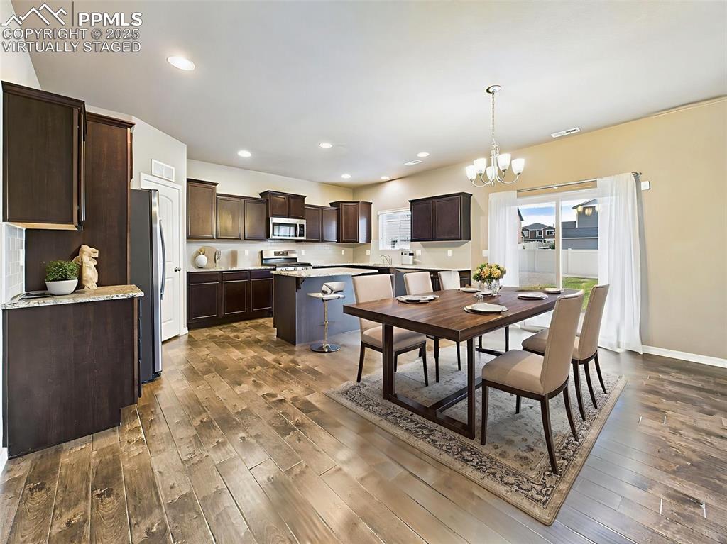 Image 13 of 50: Virtually Staged – Shown as a welcoming dining space with a full-size table