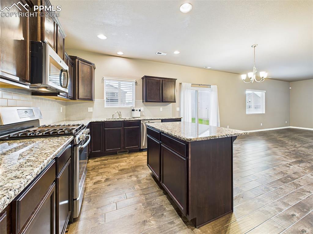 Image 16 of 50: Open sightlines from the kitchen to the living room create seamless flow fo