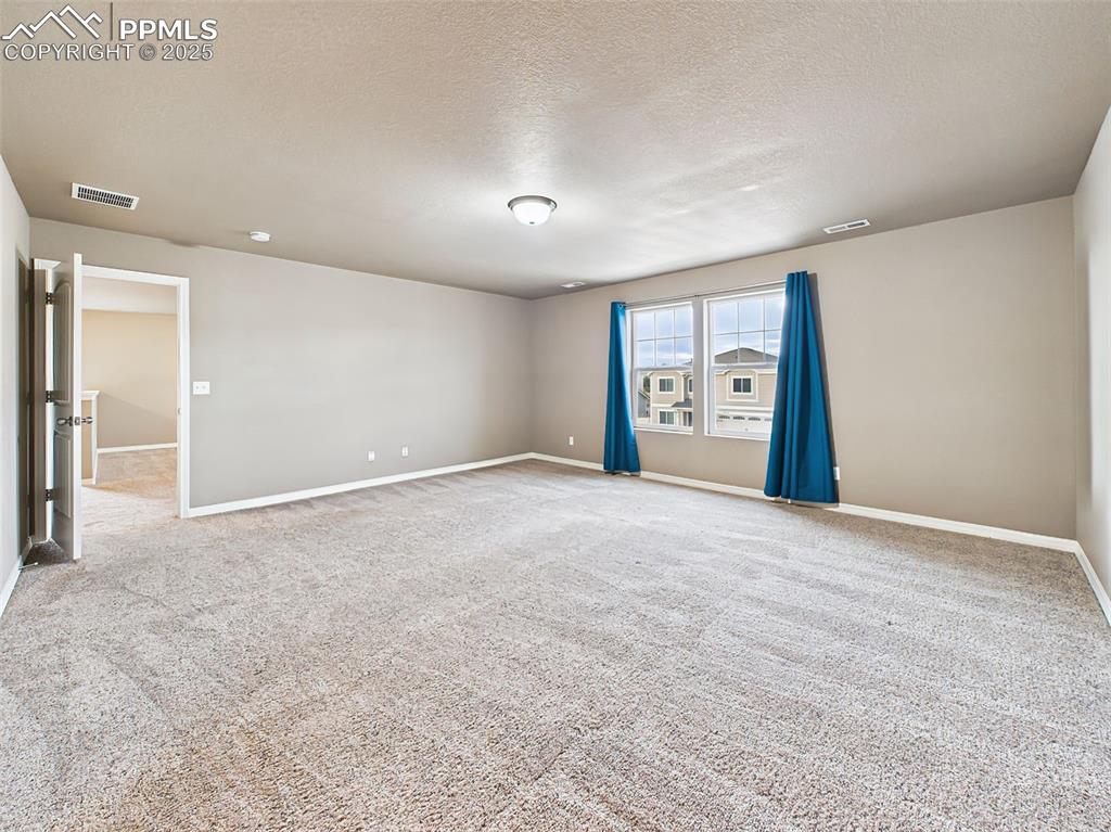 Image 27 of 50: Alternate View – Another angle of the spacious retreat with views of the ba