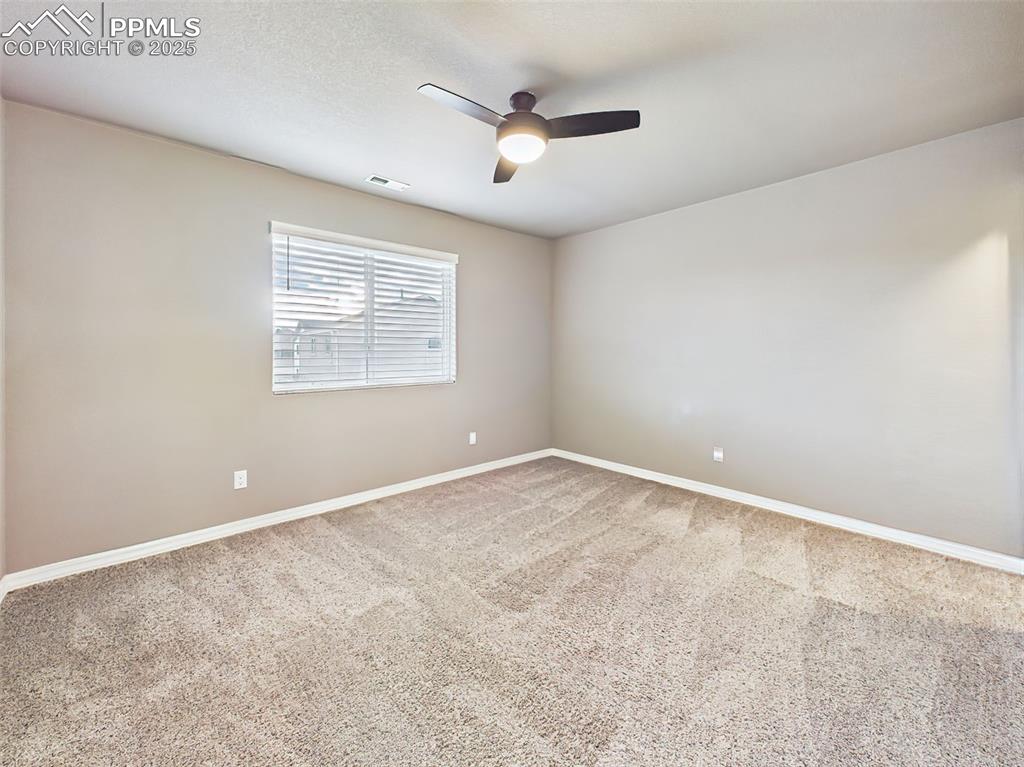 Image 35 of 50: Generously sized bedroom with neutral tones, walk-in closet, and easy acces