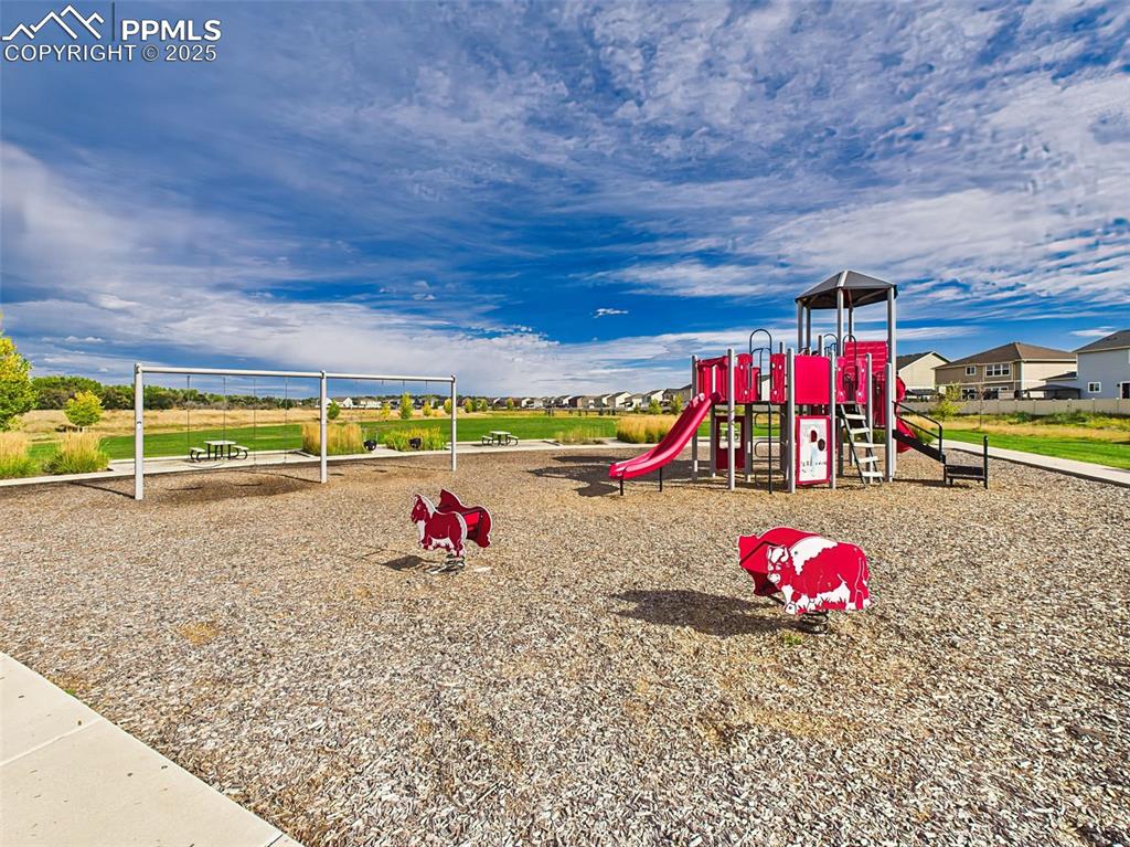 Image 45 of 50: Neighborhood Playground – Family-friendly park area with slides, swings, an
