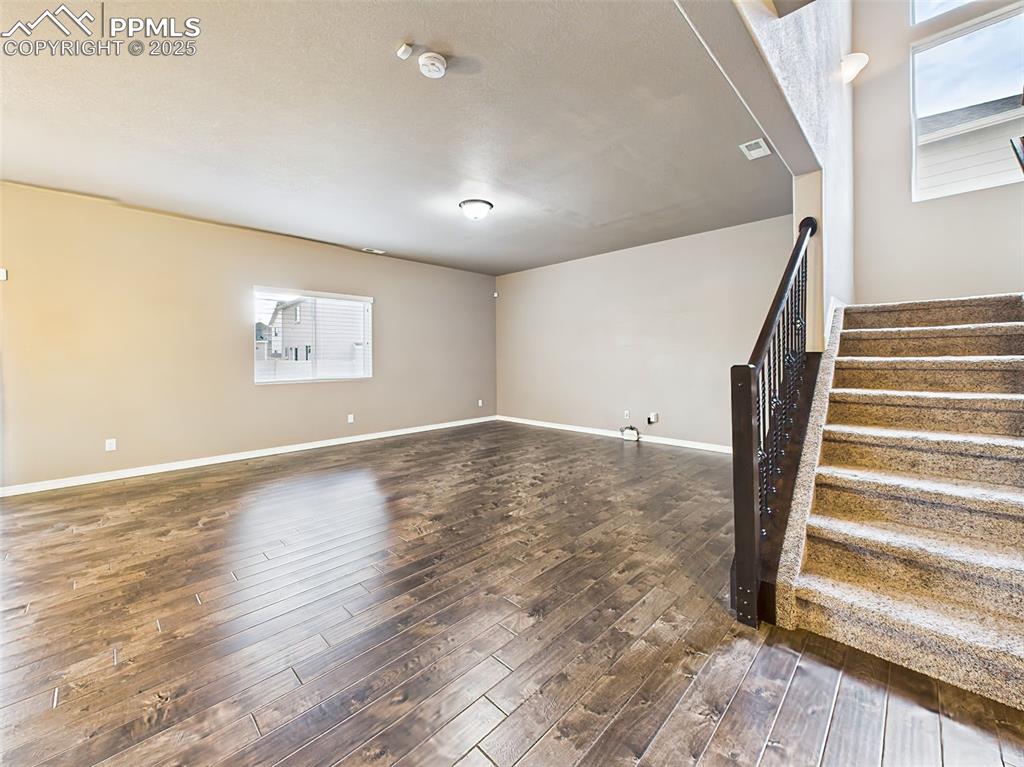Image 6 of 50: A wide-angle perspective showcasing the open concept design, stairway with