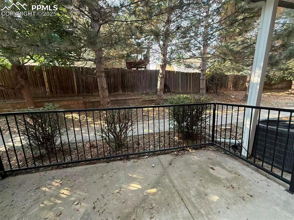 Image 12 of 13: Gate featuring a fenced backyard and a patio