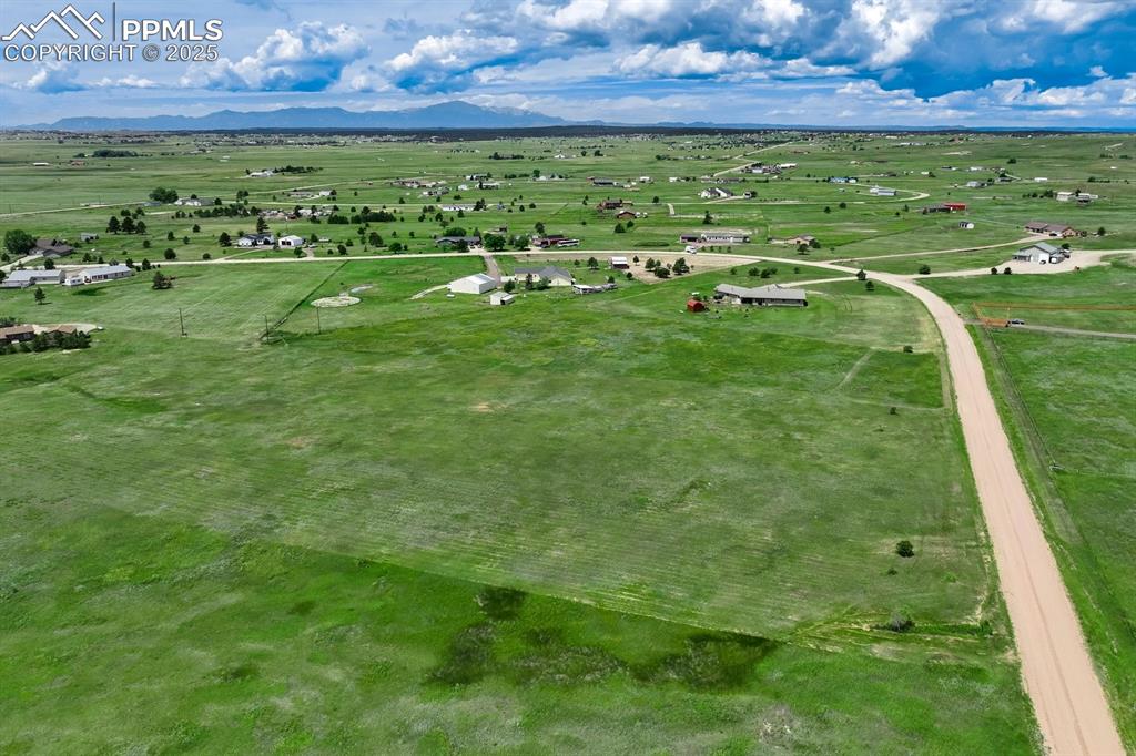Caption: Aerial view of sparsely populated area featuring a mountain backdrop