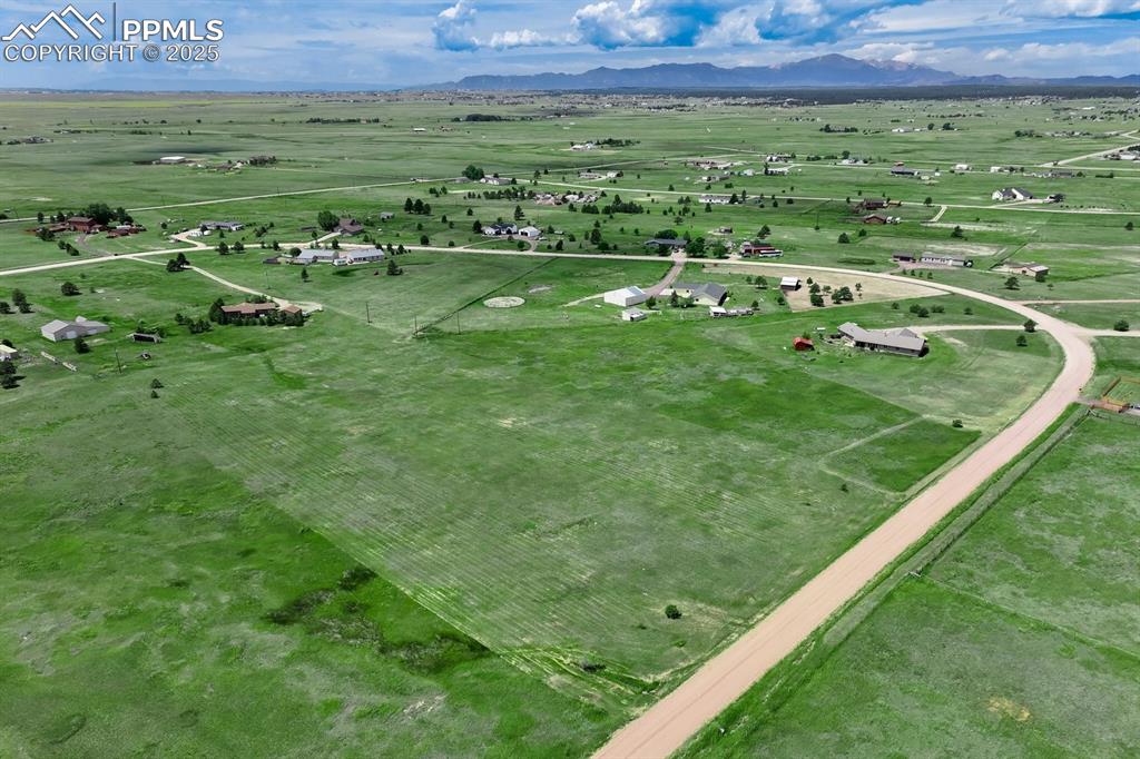 Image 20 of 20: Aerial view of sparsely populated area featuring mountains