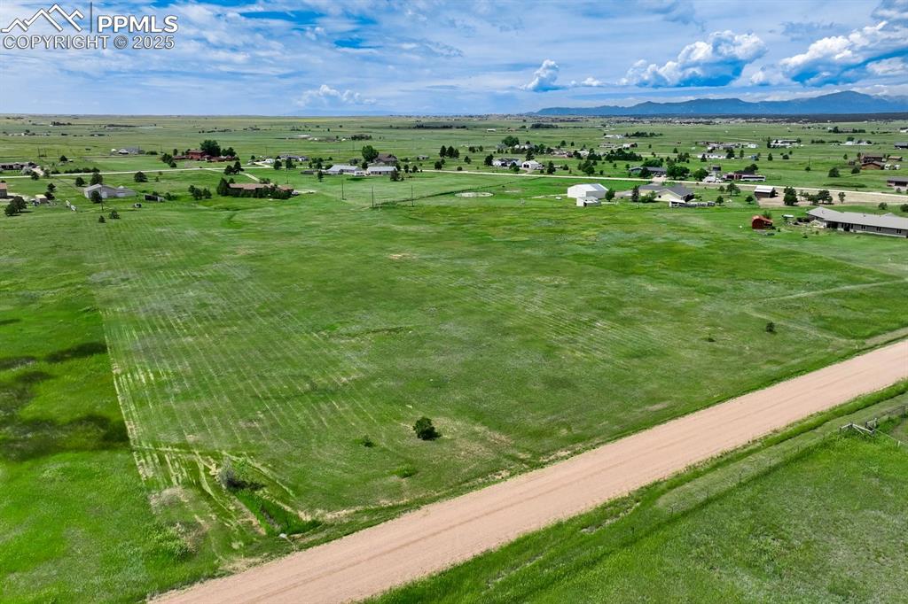Image 4 of 20: Overview of rural landscape featuring a mountainous background and a pastor