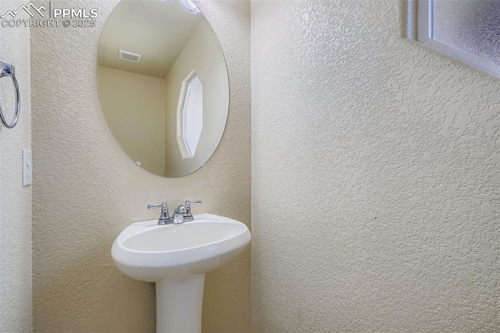 Image 14 of 49: main level bath near front entrance