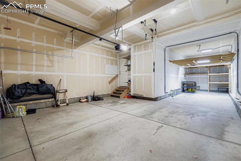 Image 39 of 49: 3 car tandem garage and workstation