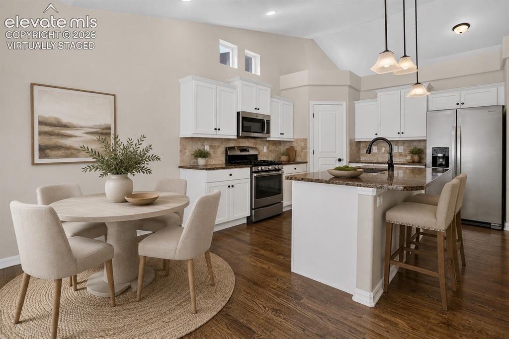 Image 12 of 50: Virtually Staged - Wood-finish flooring, white cabinetry with dark hardware