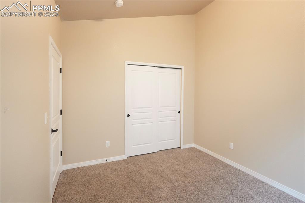 Image 18 of 44: Unfurnished bedroom with a closet and light colored carpet