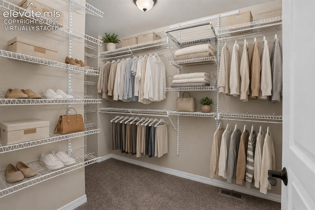 Image 24 of 50: Virtually Staged - Custom wire shelving system, multiple hanging rods, inte