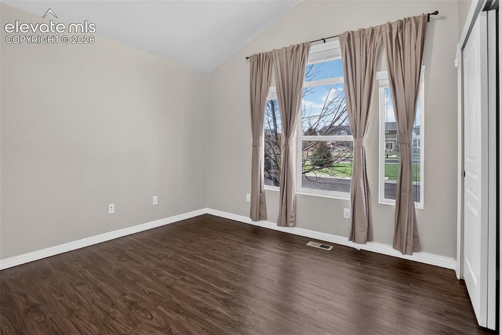 Image 29 of 50: Vaulted ceiling, durable wood-finish flooring, built-in shelving, expansive
