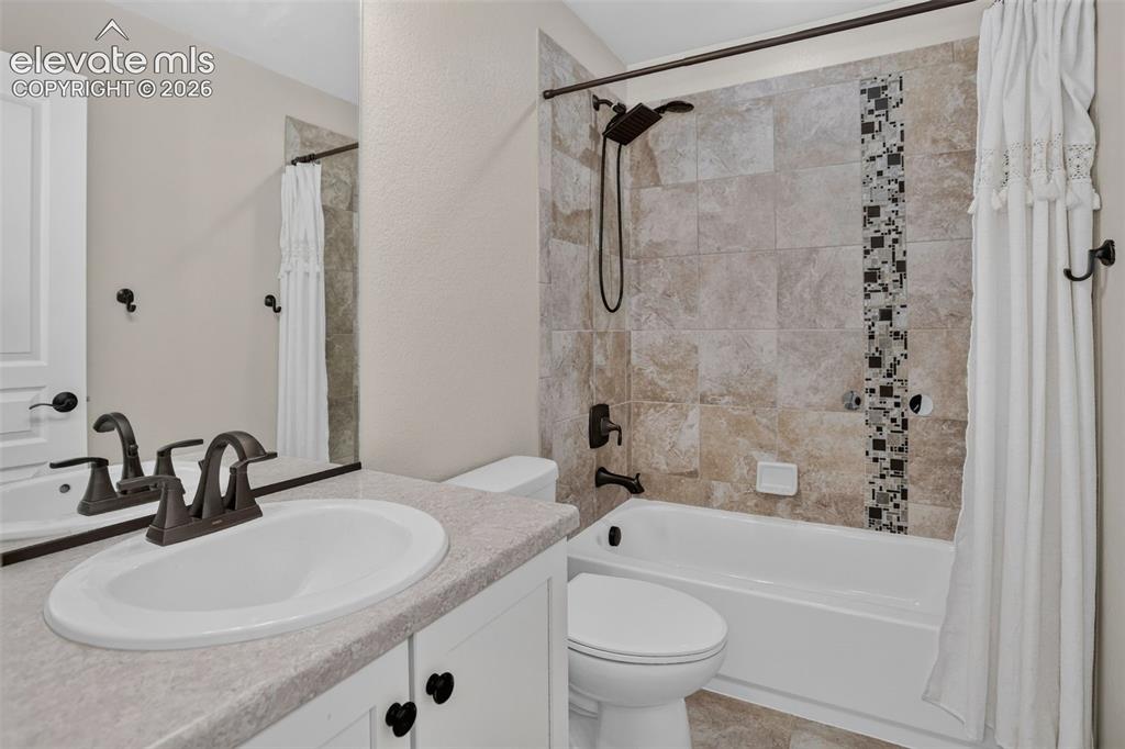Image 30 of 50: Built-in vanity with a single basin sink, counterspace, and white cabinetry