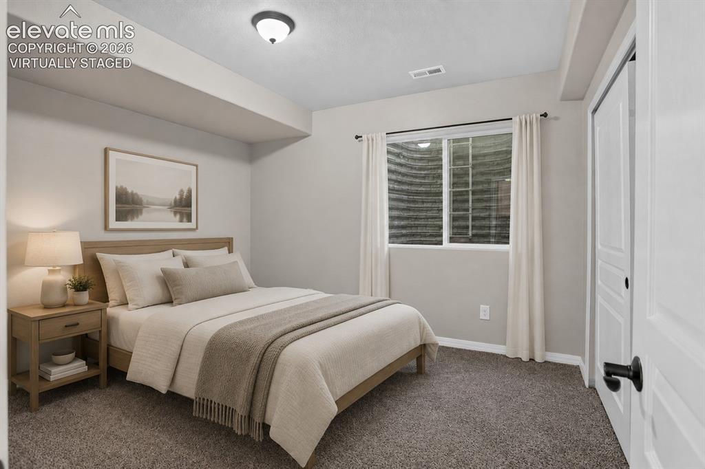 Image 36 of 50: Virtually Staged - Window with white trim, gray carpet, and a white paneled