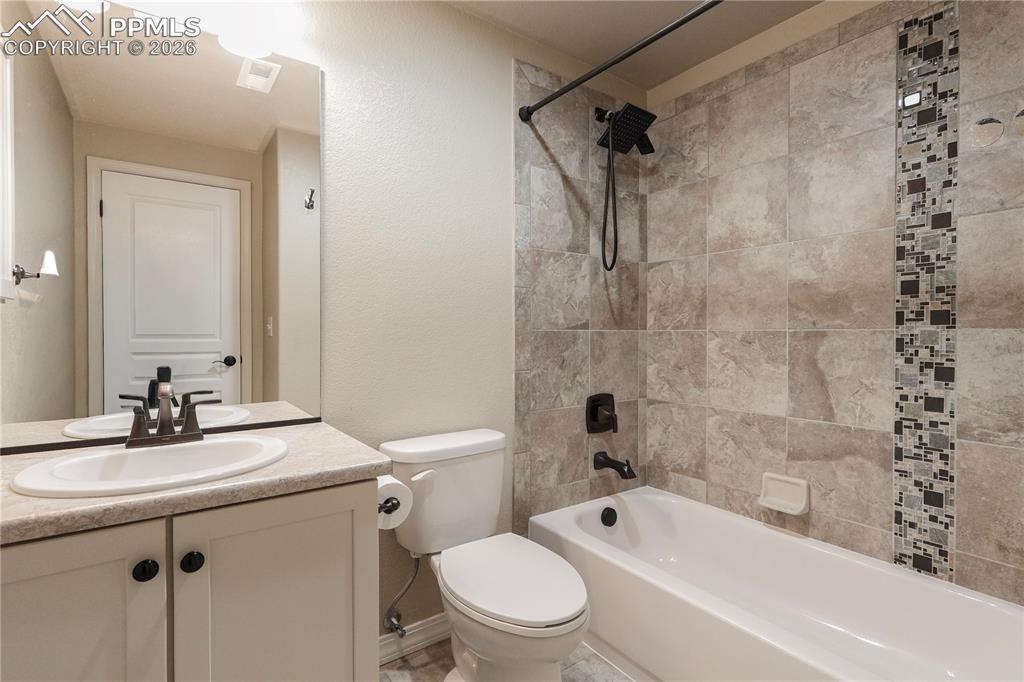 Image 38 of 44: Bathroom with vanity,  shower combination, and a textured wall
