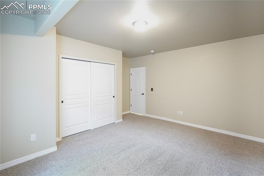 Image 39 of 44: Unfurnished bedroom with a closet and light colored carpet