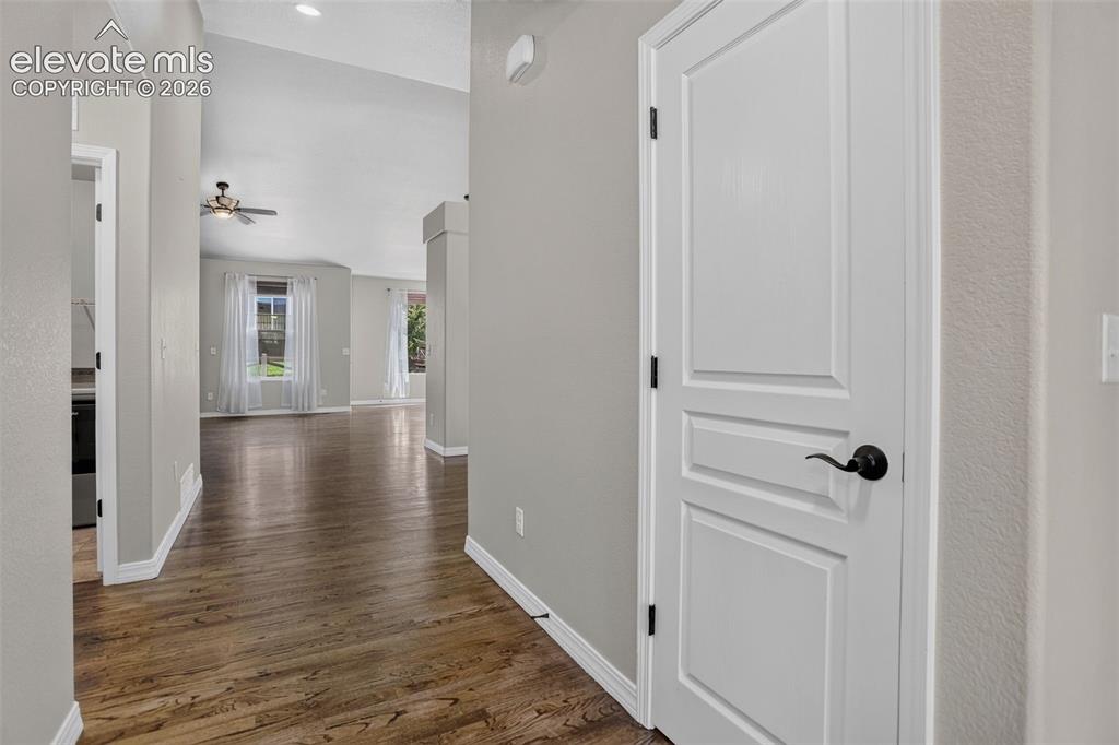 Image 4 of 50: Wood-finish flooring throughout, light gray wall paint, white trim, recesse