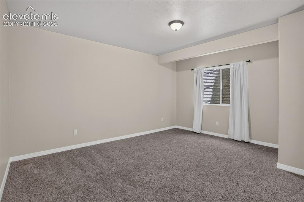 Image 42 of 50: Recessed ceiling light, neutral wall color, window with horizontal blinds,