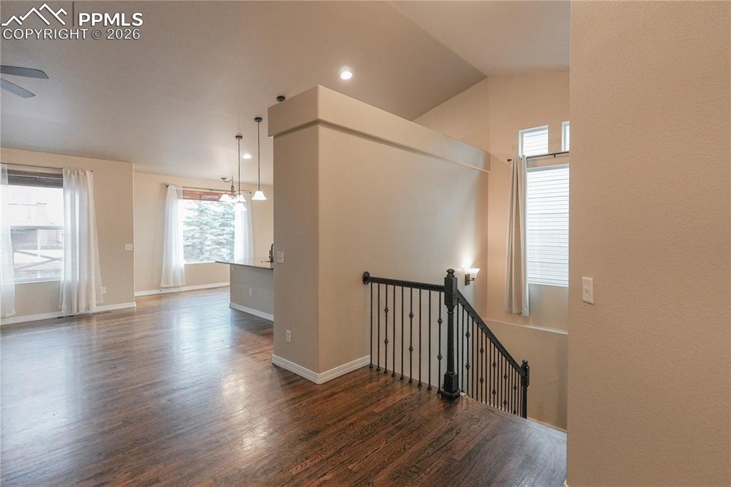 Image 7 of 44: Stairway with wood finished floors and recessed lighting