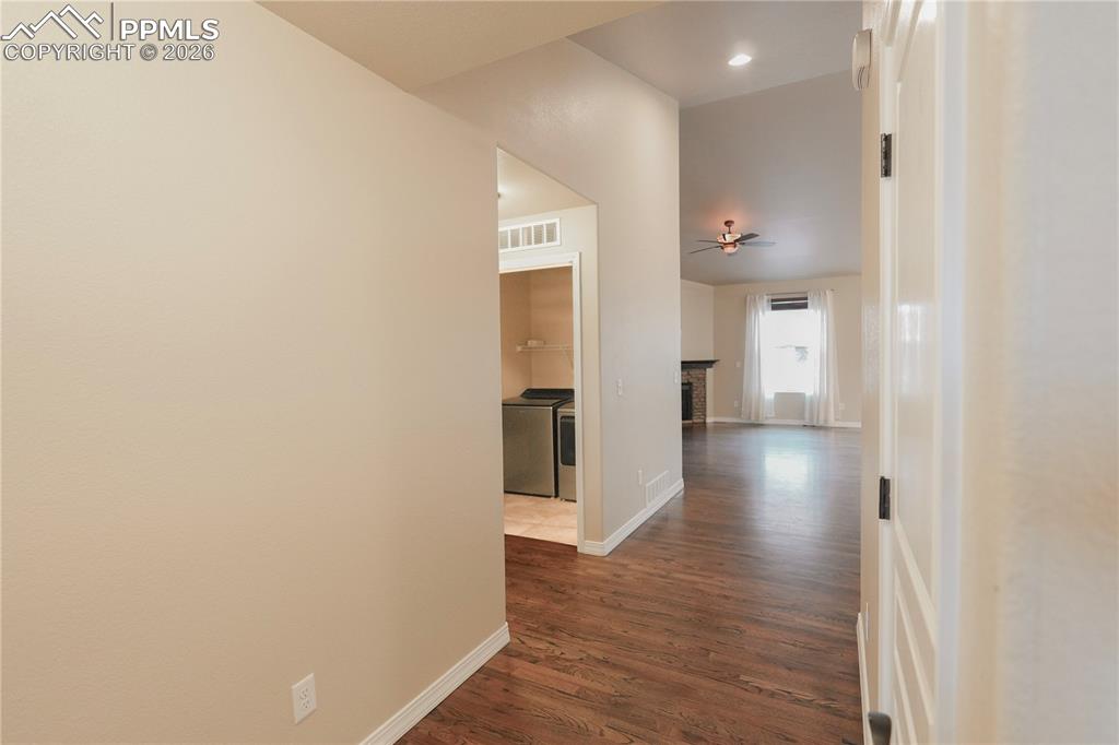 Image 8 of 44: Hallway featuring dark wood finished floors, independent washer and dryer, 