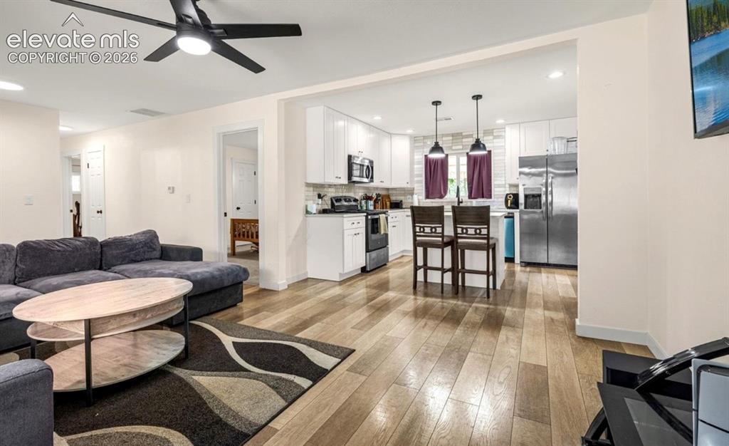 Image 3 of 11: Wood-finish flooring extends throughout the living space and kitchen