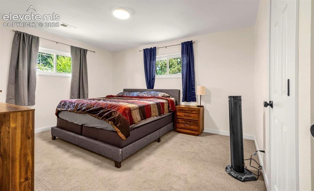 Image 5 of 11: Carpeted flooring, white trim, recessed lighting, and white paneled interio