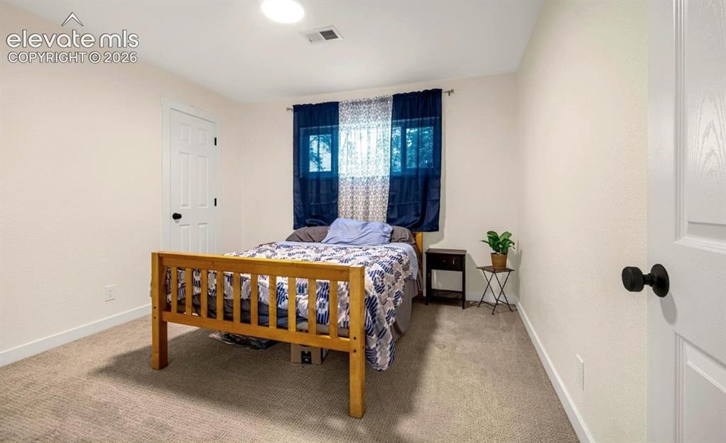 Image 6 of 11: Neutral-toned walls complement plush carpeting