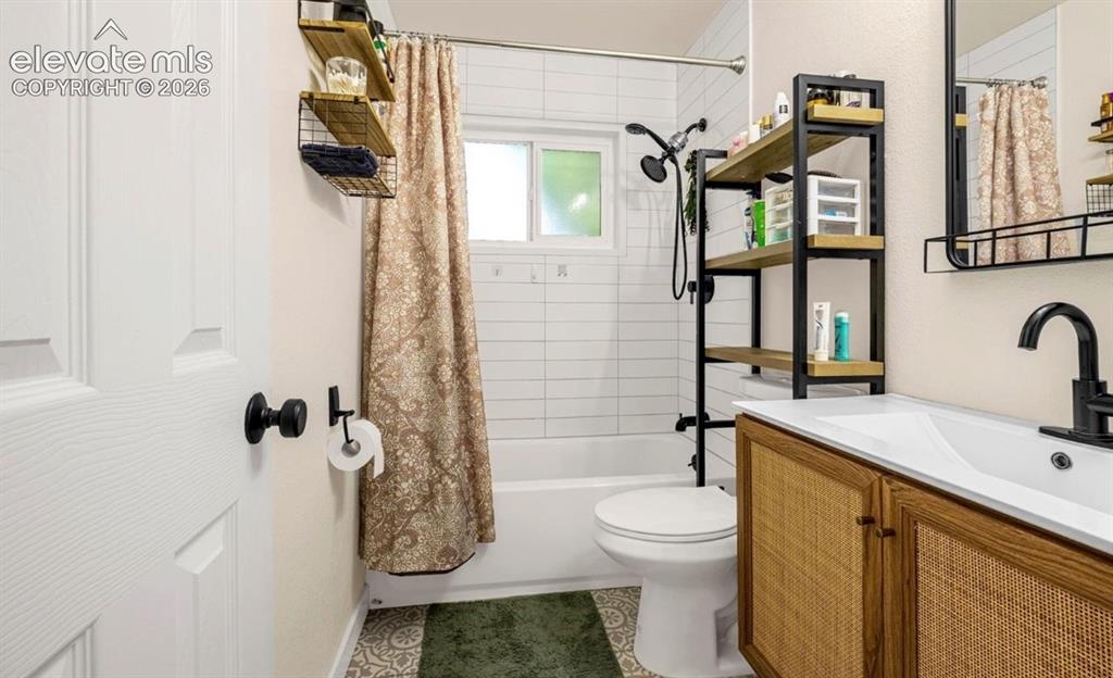 Image 7 of 11: Modern bathroom featuring a white bathtub, white subway tile surround, patt