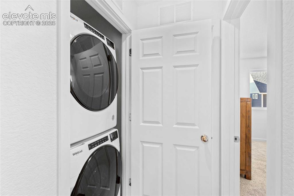 Image 16 of 25: Stackable washer and dryer unit within a dedicated closet
*photos of a mod