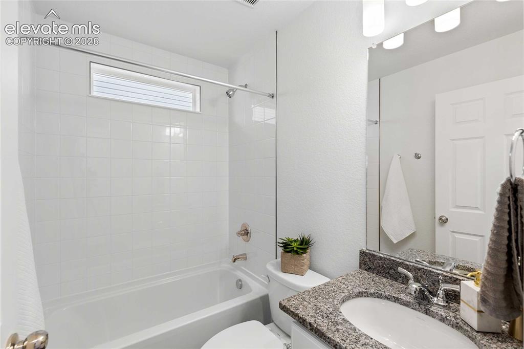 Image 21 of 25: White tile bath/shower combination with an integrated window
*photos of a 