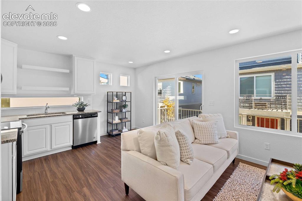 Image 7 of 25: Open-concept living space with recessed lighting, wood-finish flooring, and